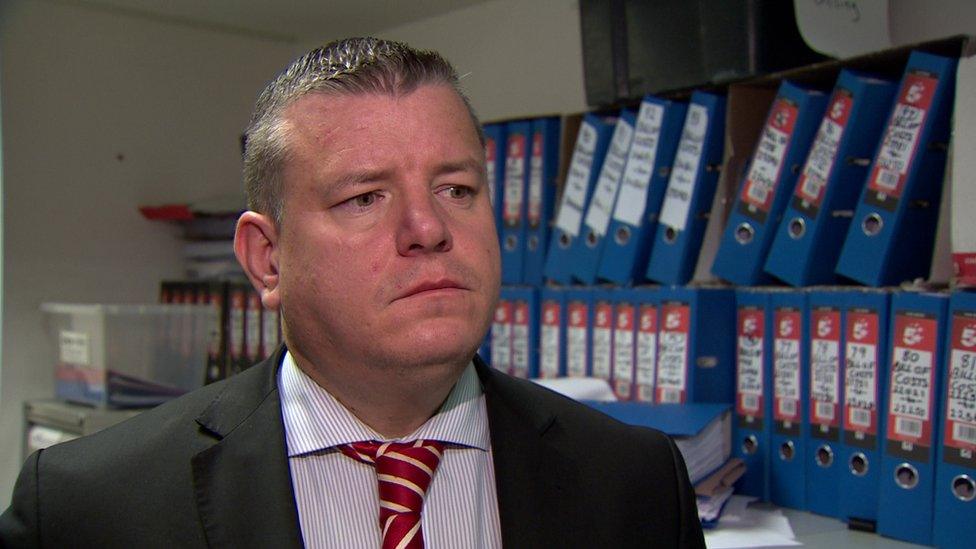 Solicitor Niall Murphy stands in his office.