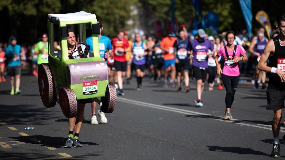 Phil-runs-while-wearing-a-large-tractor-costume