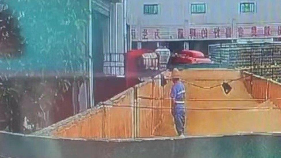 A screengrab of the viral video shows a worker appearing to urinate in a container