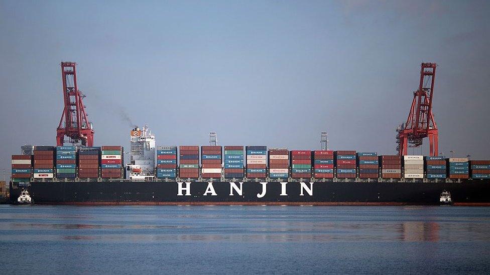 Tug boats push the Hanjin Greece container ship to dock for unloading at the Port of Long Beach, California