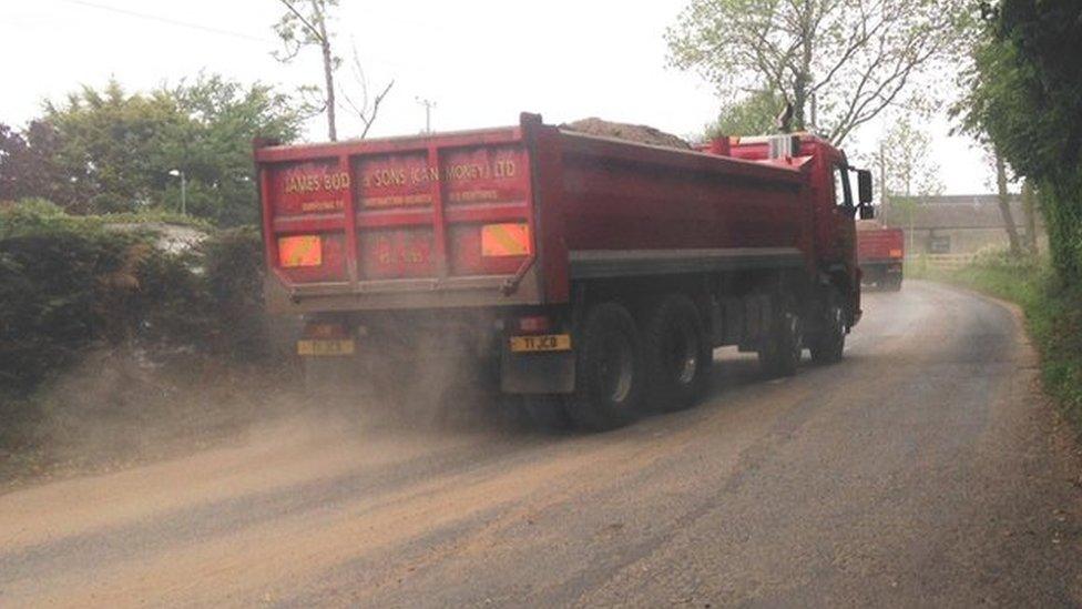 Truck driving sand away