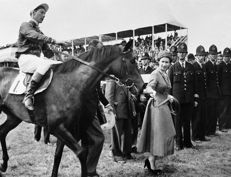 The Queen is seen with her horse Carrozza after a victory in the Epsom Oaks race on 8 June 1957