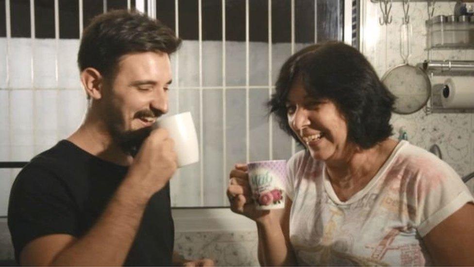 Vitor and his mother share a cup of coffee after an argument about politics