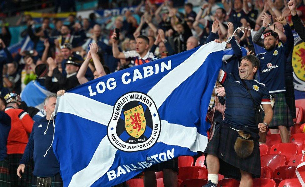 Scotland fans display a flag as they applaud the team following the UEFA Euro 2020 Championship Group D match between England and Scotland at Wembley Stadium