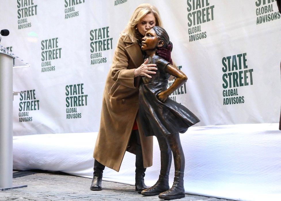 US Congresswoman Carolyn Maloney kisses the Fearless Girl statue at its unveiling ceremony at its new location outside the New York Stock Exchange near Wall Street in New York on 10 December 2018