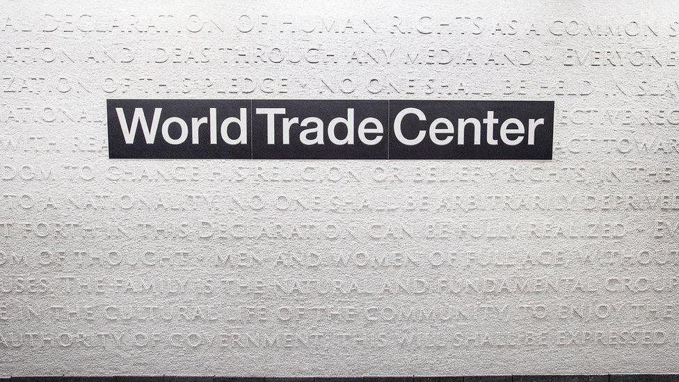 White marble mosaic covers the wall around the sign World Trade Center