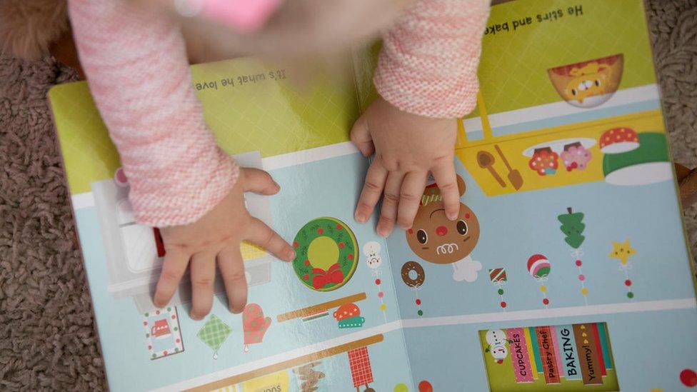 Child's hands on a book