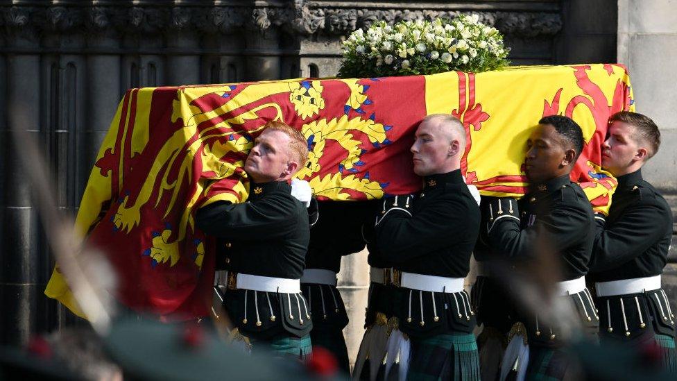 Royal guards carry Queen Elizabeth II's coffin at the start of the procession from the Palace of Holyroodhouse to St Giles' Cathedral.