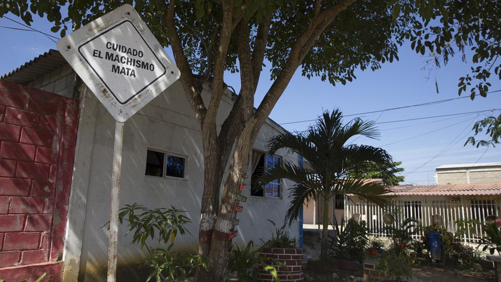 A view of a sign reading, "careful, machismo kills" in the City of Women