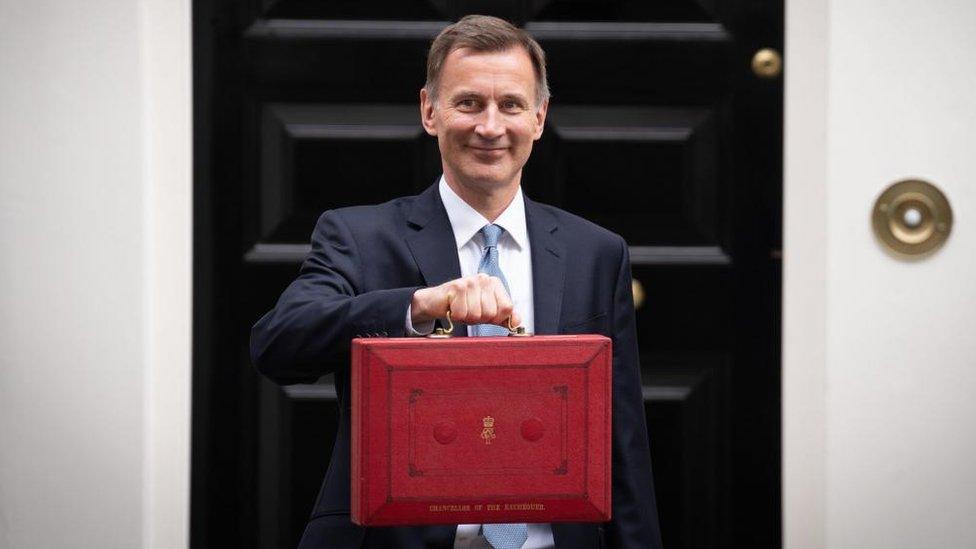 Chancellor Jeremy Hunt posing before delivering his March 2023 Budget