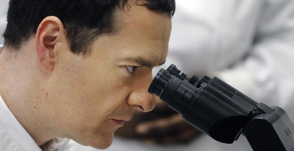 George Osborne uses a microscope