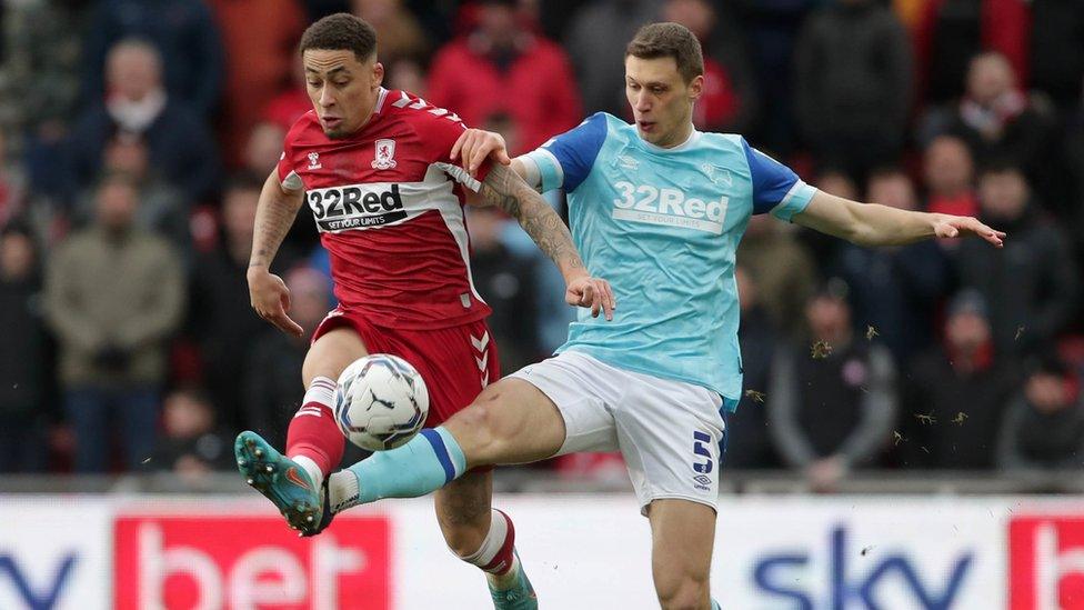 Middlesbrough player and Derby player go for the ball