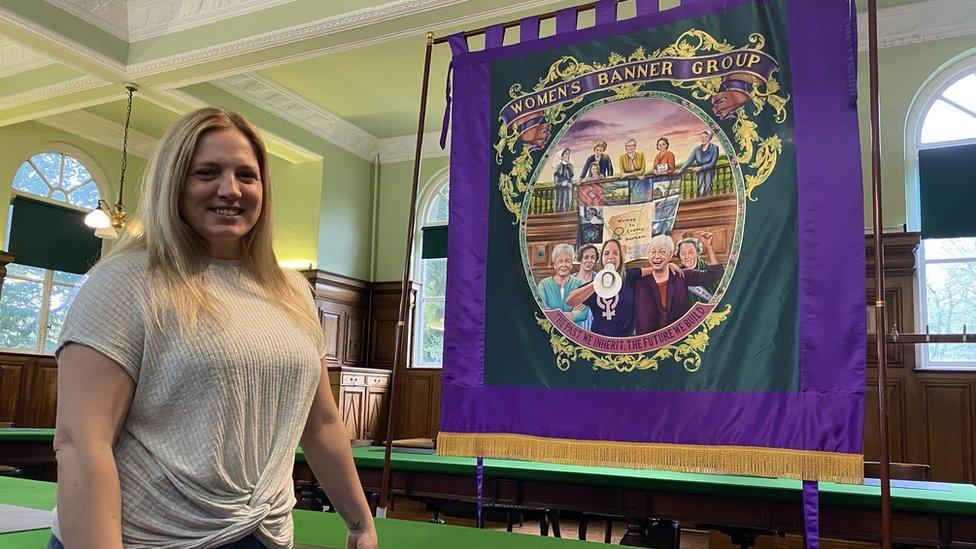 Laura Daly with the banner