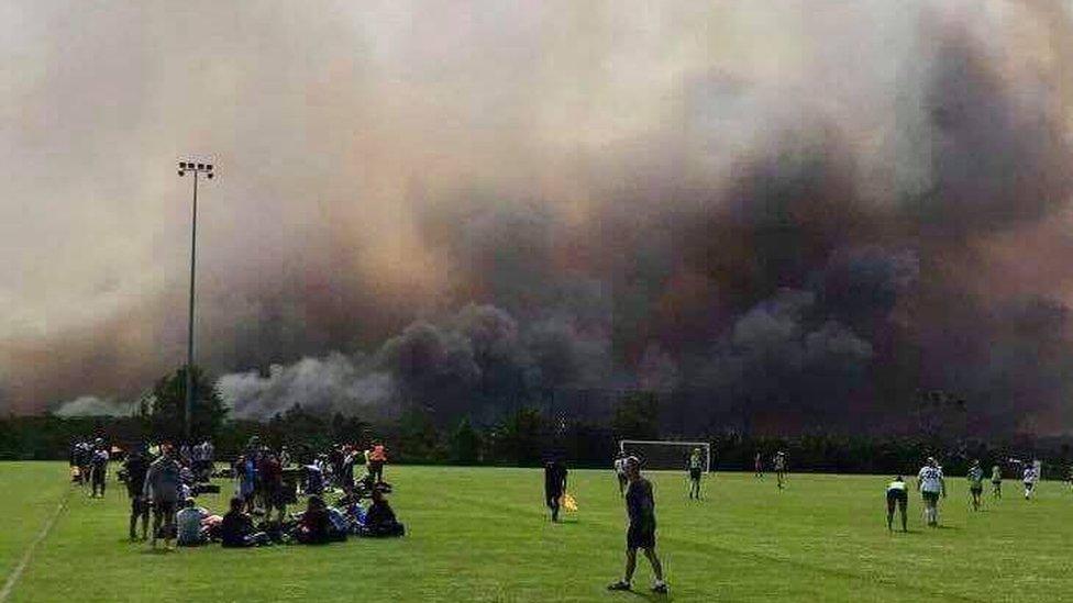 The fire seen from a football match in Barden Ridge, one of the affected suburbs