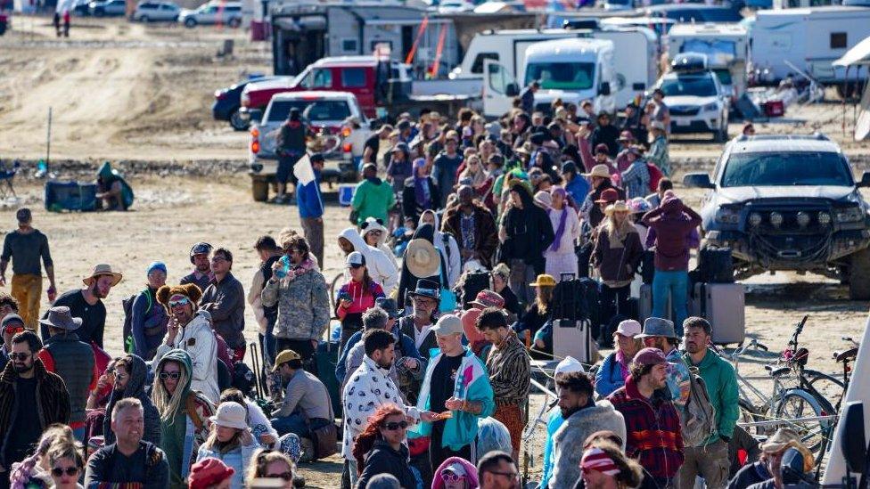 Hundreds of Burning Man attendees who planned to leave on buses wait for information about when they will be able to leave