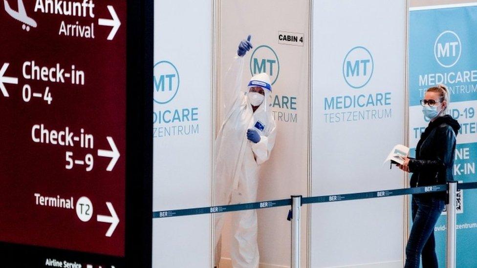 Medical staff in front of coronavirus test station at the Berlin Brandenburg Airport Terminal 1, Schoenefeld, near Berlin, Germany, 26 March 2021