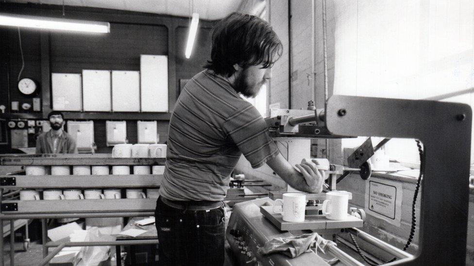 A man making mugs, his hand turns back on itself