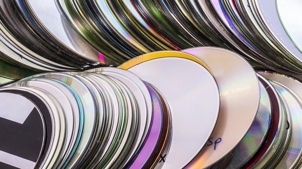 CDs lying in a pile.