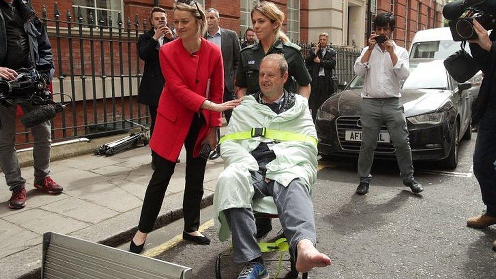 BBC"s Laura Kuenssberg comforts her her colleague, BBC cameraman Giles Wooltorton, after the car carrying Jeremy Corbyn ran over his foot as it arrived at the Institute of Engineering in London