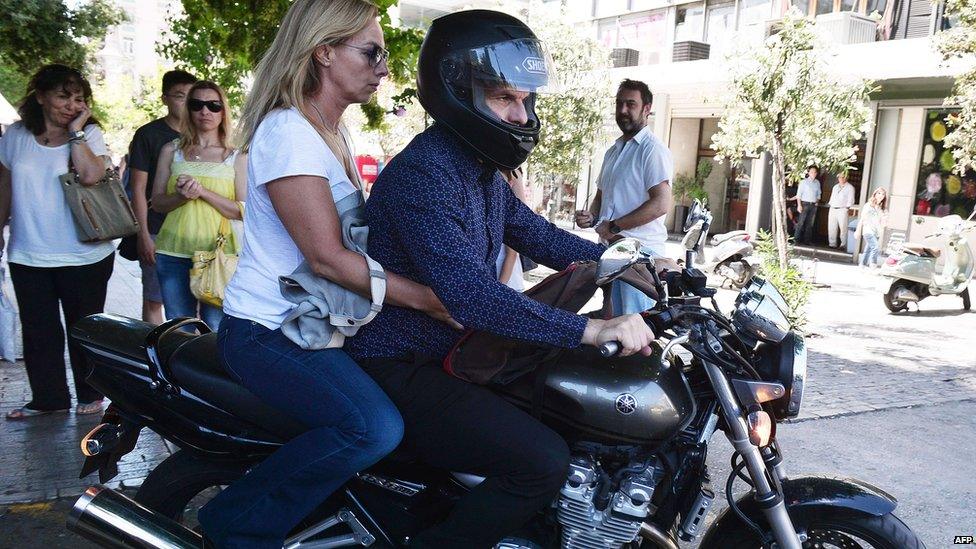 Yanis Varoufakis leaves on his motorcycle with wife Danai after his resignation at ministry of finance. 6 July 2015