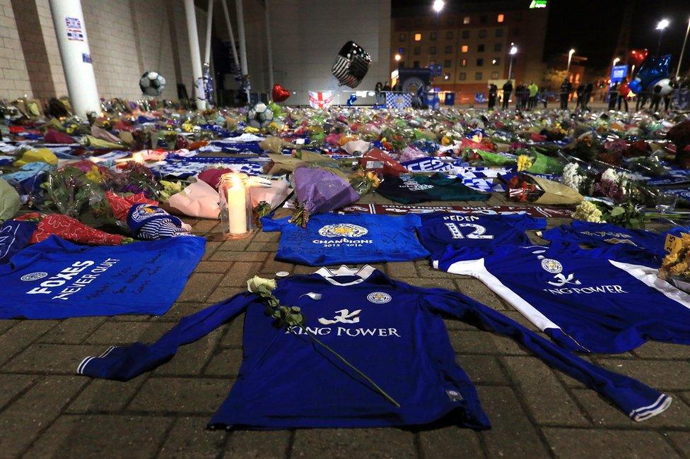 Tributes are seen as mourners pause to pay tributes after the helicopter crash at The King Power Stadium on October 28, 2018 in Leicester, England