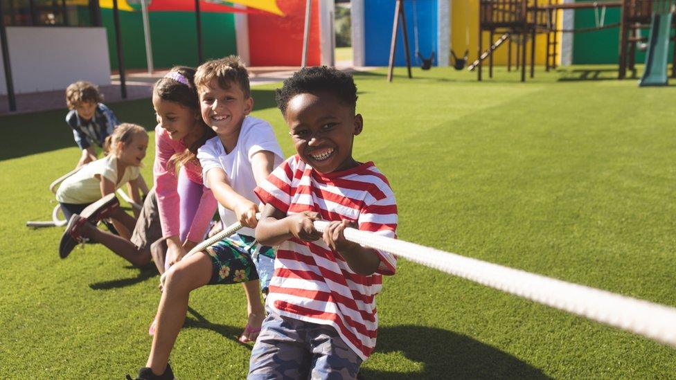 Group-of-school-kids-playing-tug-of-war.