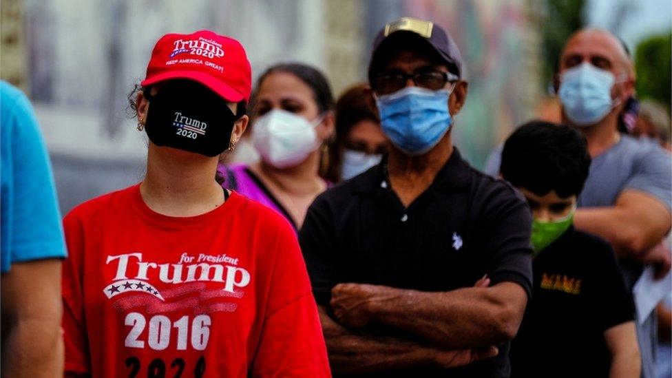 A Trump supporter queues up to cast a vote in Florida