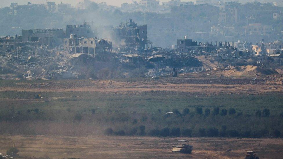 A tank maneuvers near Gaza, amid the ongoing conflict between Israel and the Palestinian group Hamas, as seen from south Israel November 17