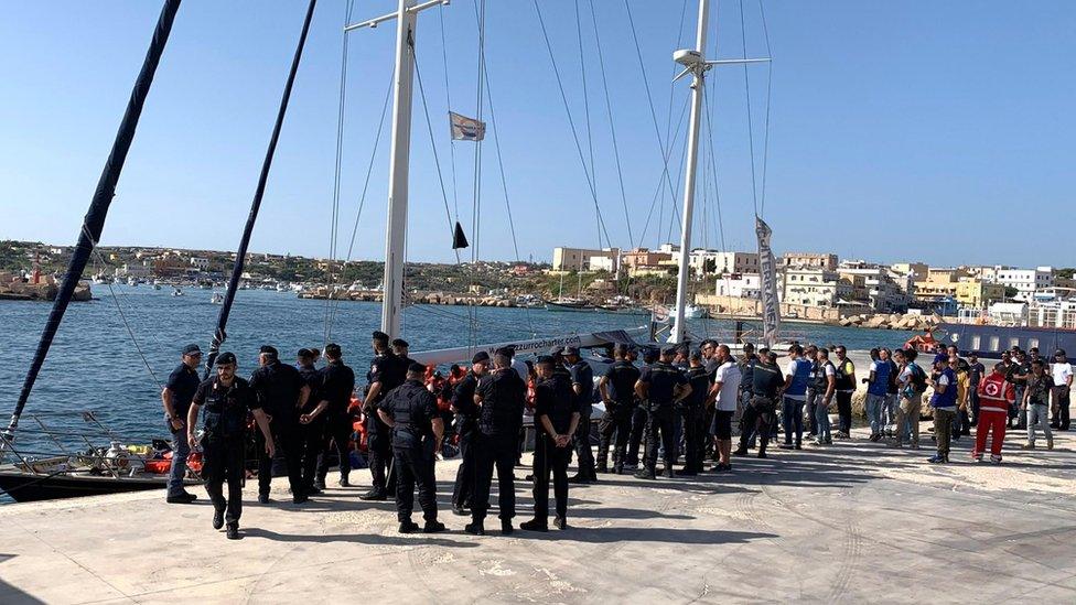 Italian law enforcement officers stand on the pier as the Italian NGO Mediterranea Saving Humans" Alex migrant rescue ship carrying 41 migrants rescued off Libya Thursday arrives in the port of Lampedusa,