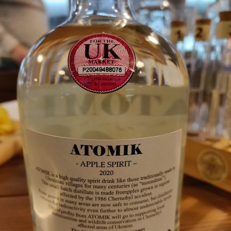 A bottle of Atomik apple spirit with its UK excise stamp