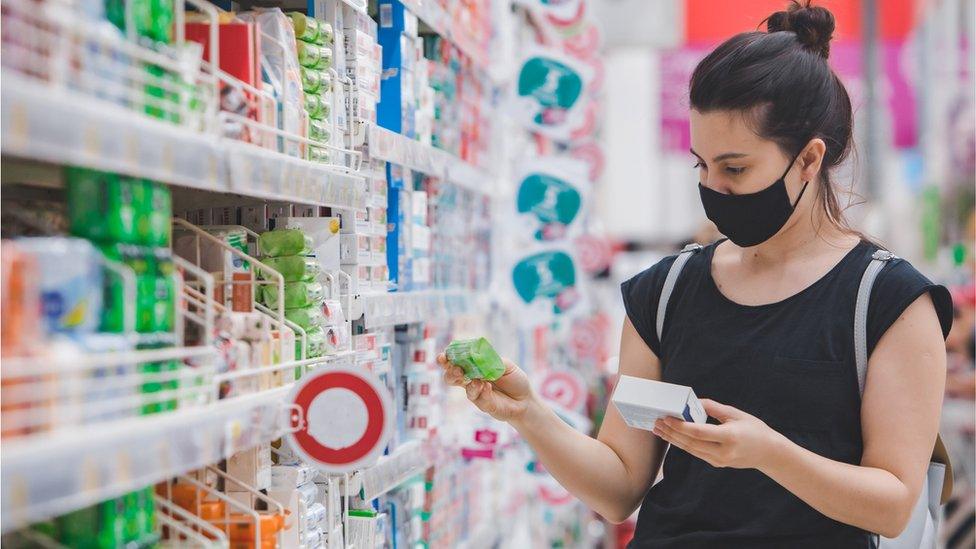 woman in mask in shop