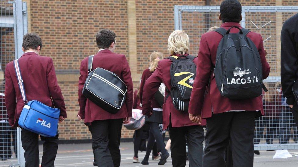 Pupils walking through a school playground