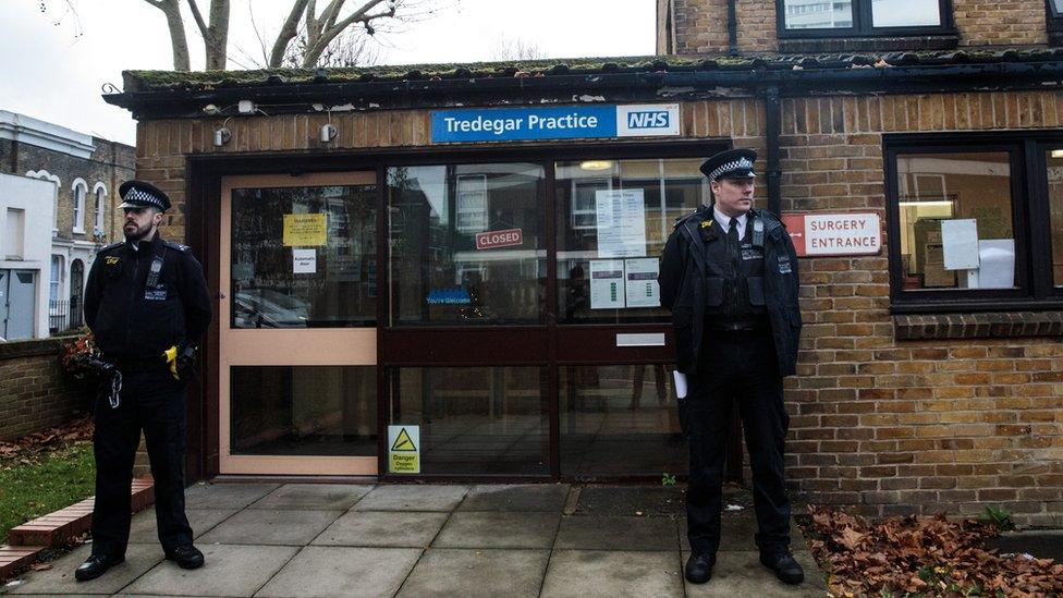 Police officers outside a GP practice in London