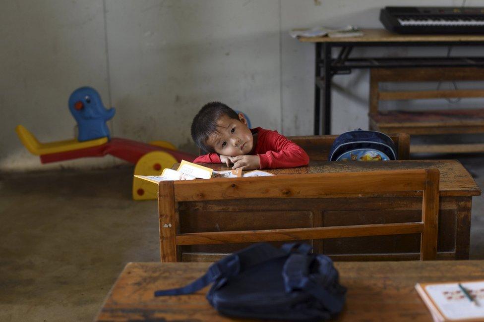 A student rests his head on a table inside a classroom of Dalu primary school in Gucheng township of Hefei, Anhui province, China, 8 September 2015.