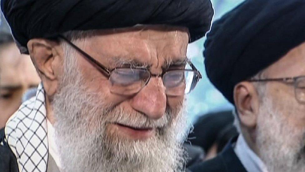 An image grab from an Iran Press video shows Iranian Supreme Leader Ayatollah Ali Khamenei (L) weeping as he recites a prayer in front of the coffin of Iranian military commander Qasem Soleimani during a funeral procession in the capital Tehran on 6 January 2020