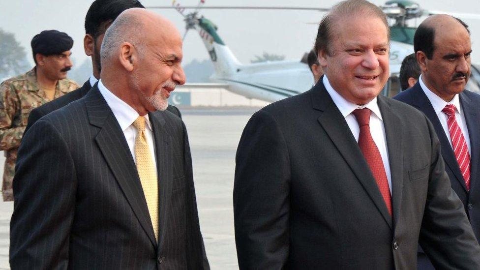Pakistan's Prime Minister Nawaz Sharif (R) walks with Afghan President Ashraf Ghani (L) upon his arrival at the military Nur Khan airbase in Rawalpindi on December 9, 2015.