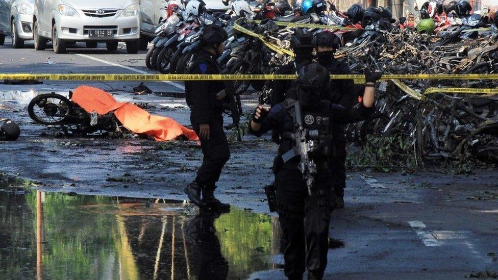 Indonesian police patrol outside a church after a suicide bomb in Surabaya, Indonesia. Photo: 13 May 2018