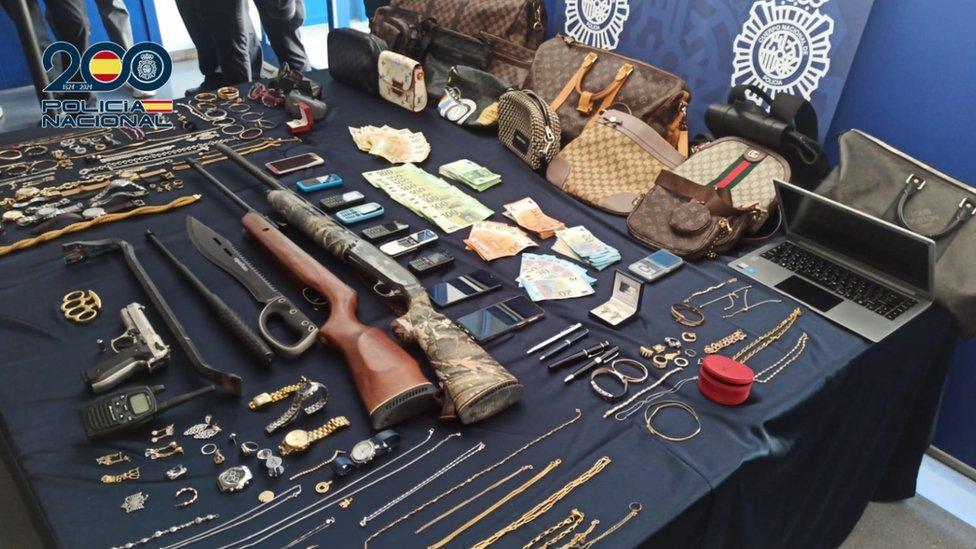 Stash of jewellery, bags, watches, mobile phones, cash and weapons found by Spanish police