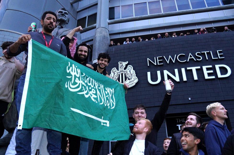 Fans with Saudi flag