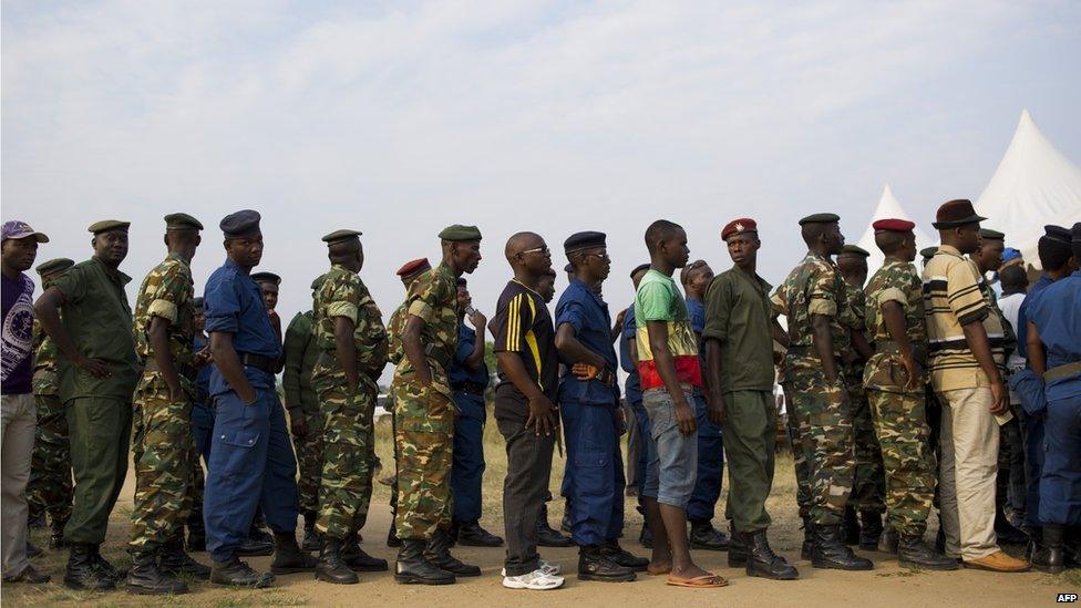 Civilians, army soldiers and police queue to vote in the opposition stronghold of Musaga in Bujumbura on June 29, 2015