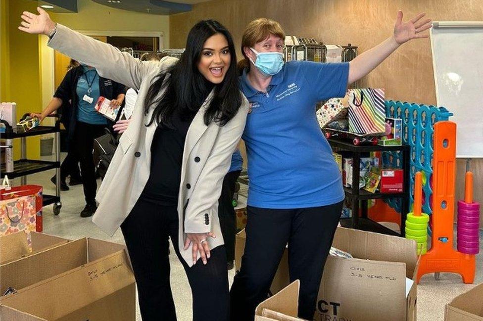 Afshan Azad and NHS worker with gift boxes