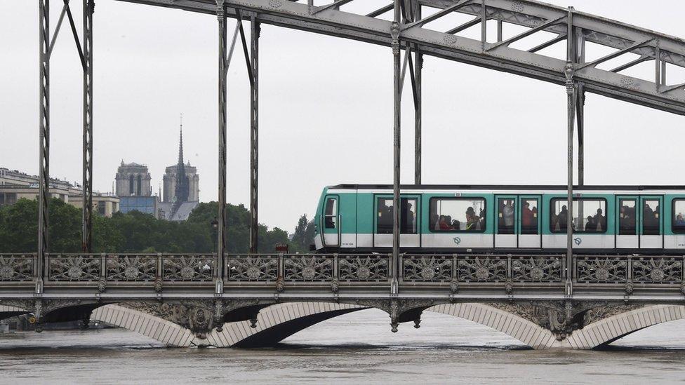 A Paris subway train passes on the Viaduc d"Austerlitz bridge on June 4, 2016, above the Seine river