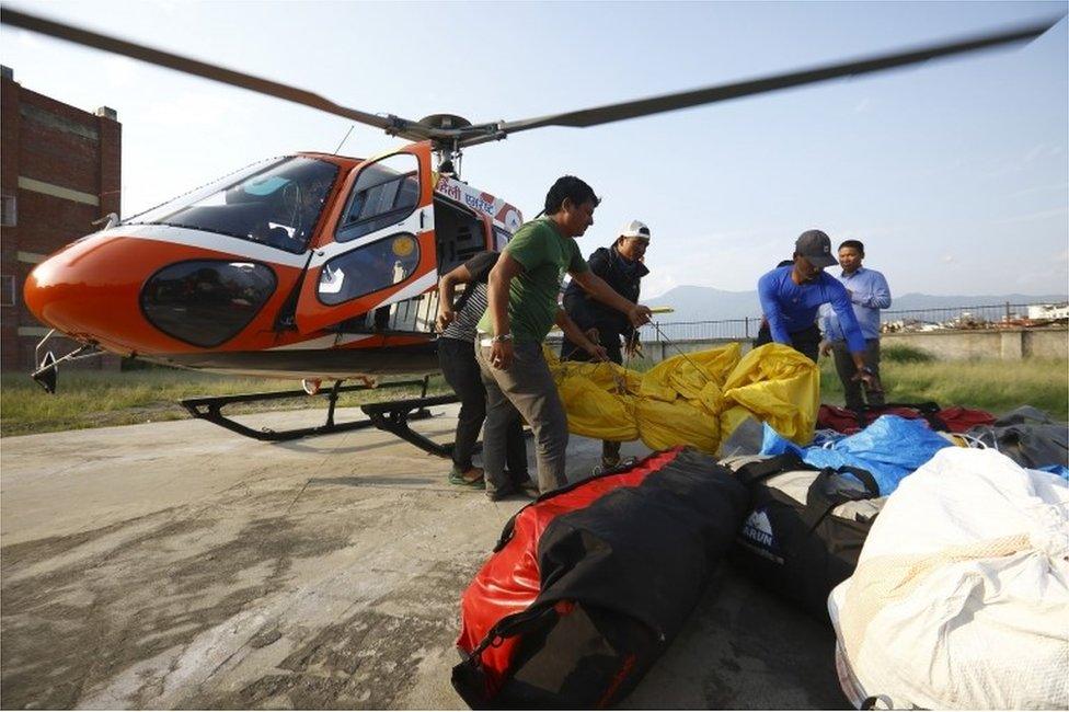 Officials carry the bodies of Indian climbers recovered from Mount Everest and airlifted to Teaching Hospital in Kathmandu on May 28, 2017.