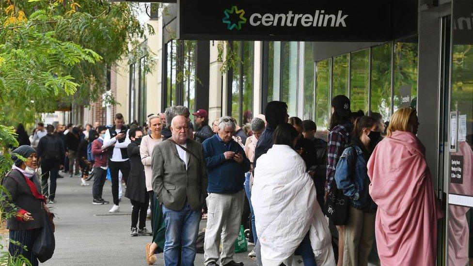 Hundreds of people queue outside an Australian government welfare centre, Centrelink, Melbourne