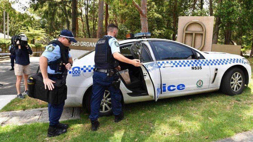 Police officers outside the Scientology complex in Sydney's north