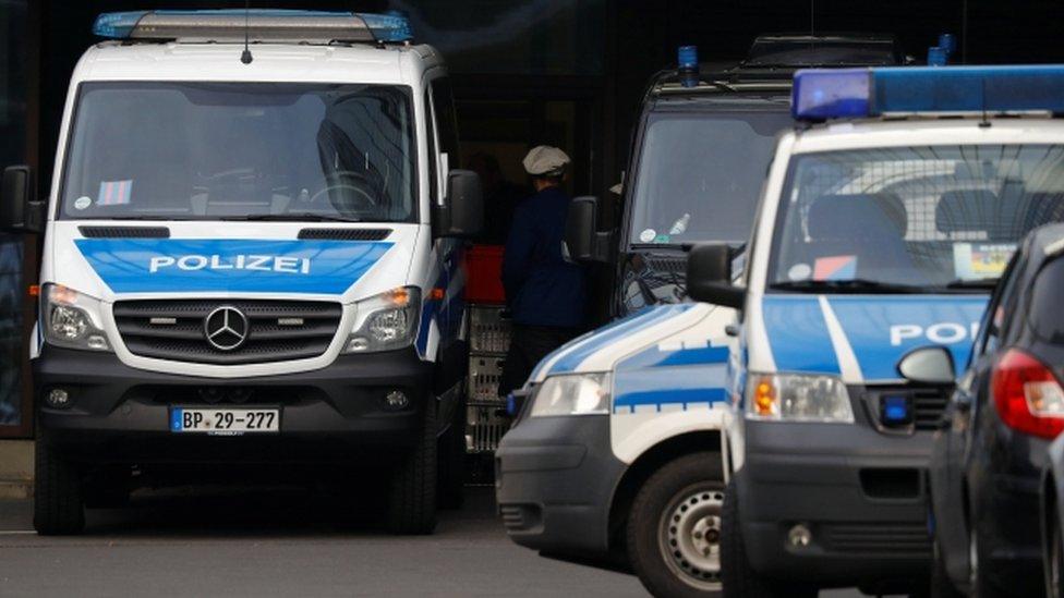 Police cars outside Deutsche Bank offices