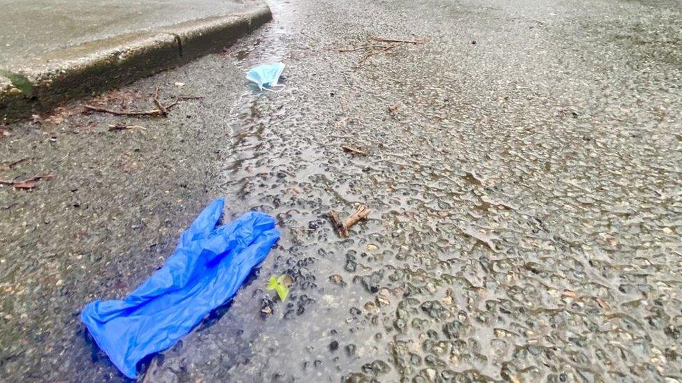 Discarded disposable face mask and glove