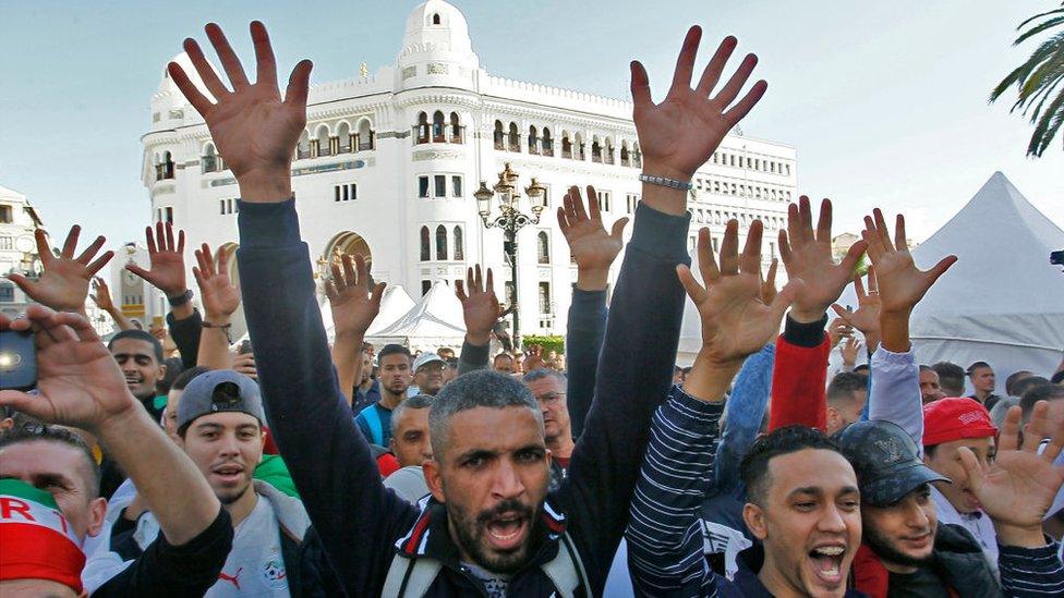 Protesters holding up their hands outside the central post office