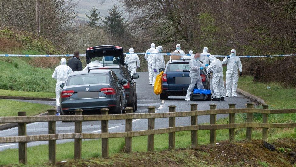 Forensic investigation officers examine the scene of the attempted bomb attack