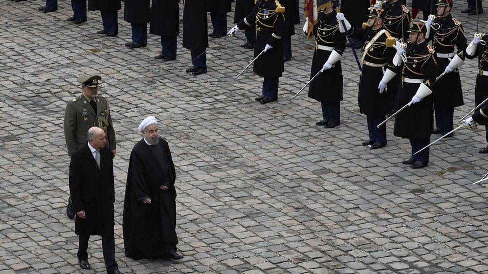 French Foreign Minister Laurent Fabius (L) walks next to Iranian President Hassan Rouhani (3rd L) during a welcoming ceremony on January 28, 2016 at the Invalides in Paris.